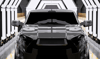 Front of a new vehicle on an automotive production line, representing Thermylene™ PP-GF40% front-end module applications.