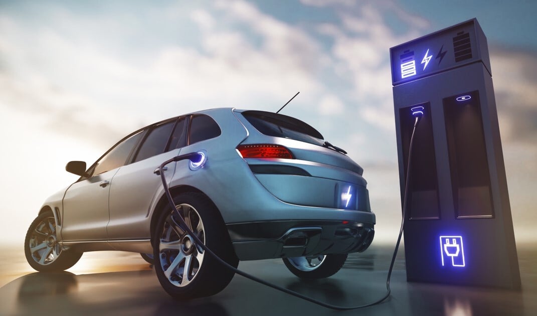 Electric vehicle charging at a station, representing the growing demand for high-voltage connectors in xEVs and the role of Asahi Kasei resin technologies.