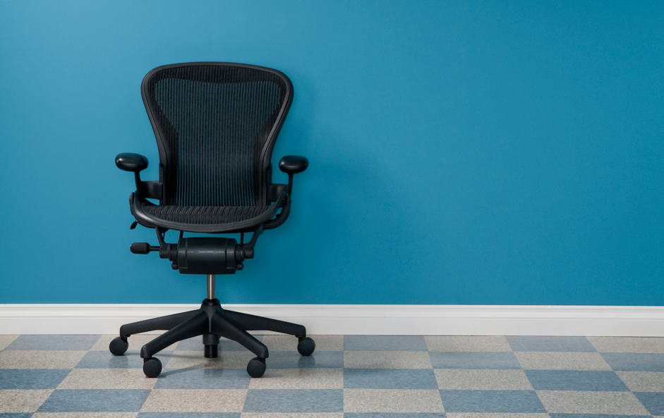 Modern office chair with structural molded plastic frame, armrests, and base designed for strength and long-term appearance