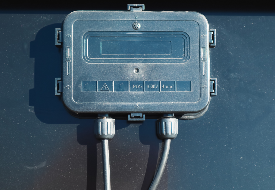 Solar junction box mounted on a photovoltaic panel using durable XYRON™ resin for weather resistance and electrical safety.